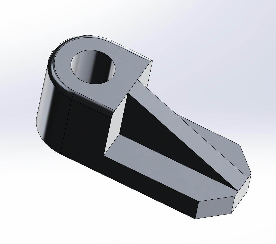 CAD render of a wedge-shaped part with a cylindrical boss and through-hole